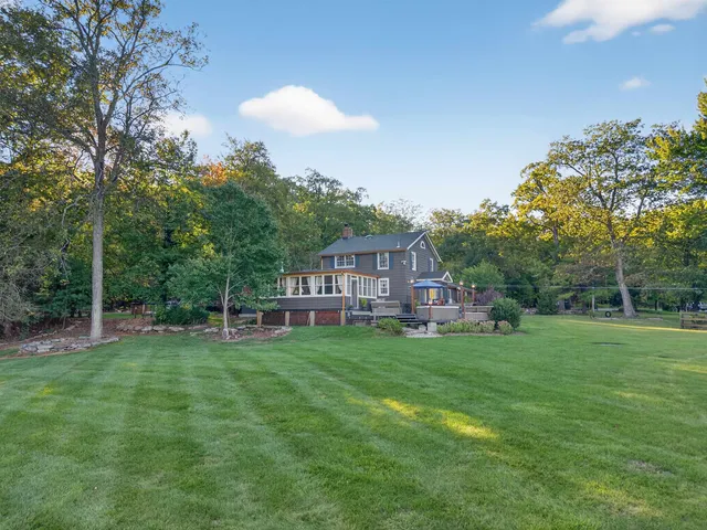 a view of a house with a yard and sitting area