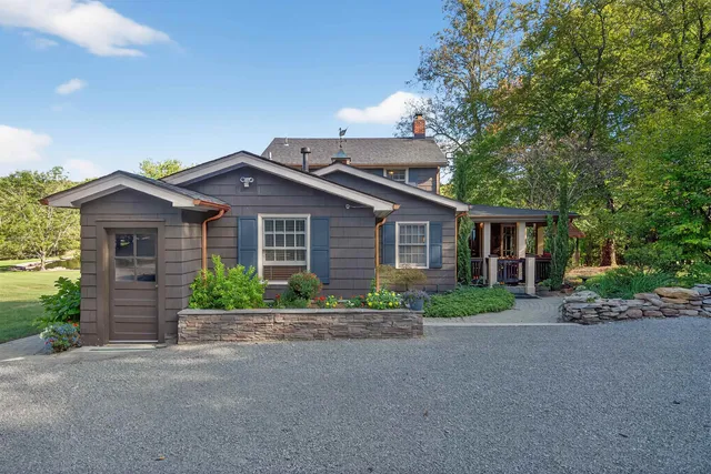 a front view of a house with a garden and yard