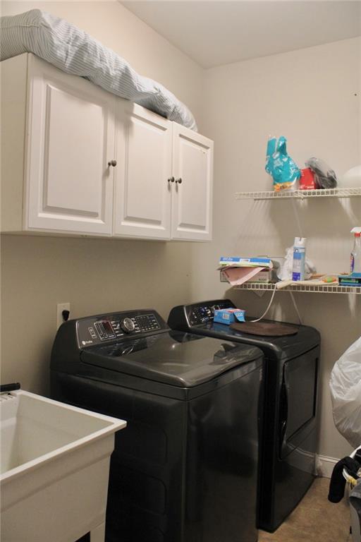 125 Trailwood Road Valdosta, GA 31602 - Photo 9 of 19 a utility room with a sink a stove and cabinets