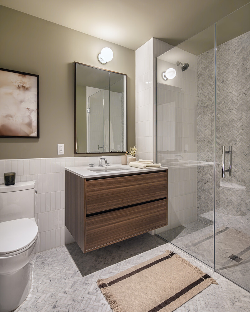 335 8th Avenue, Unit 717 Manhattan, NY 10001 - Photo 6 of 13 a bathroom with a sink a toilet and mirror