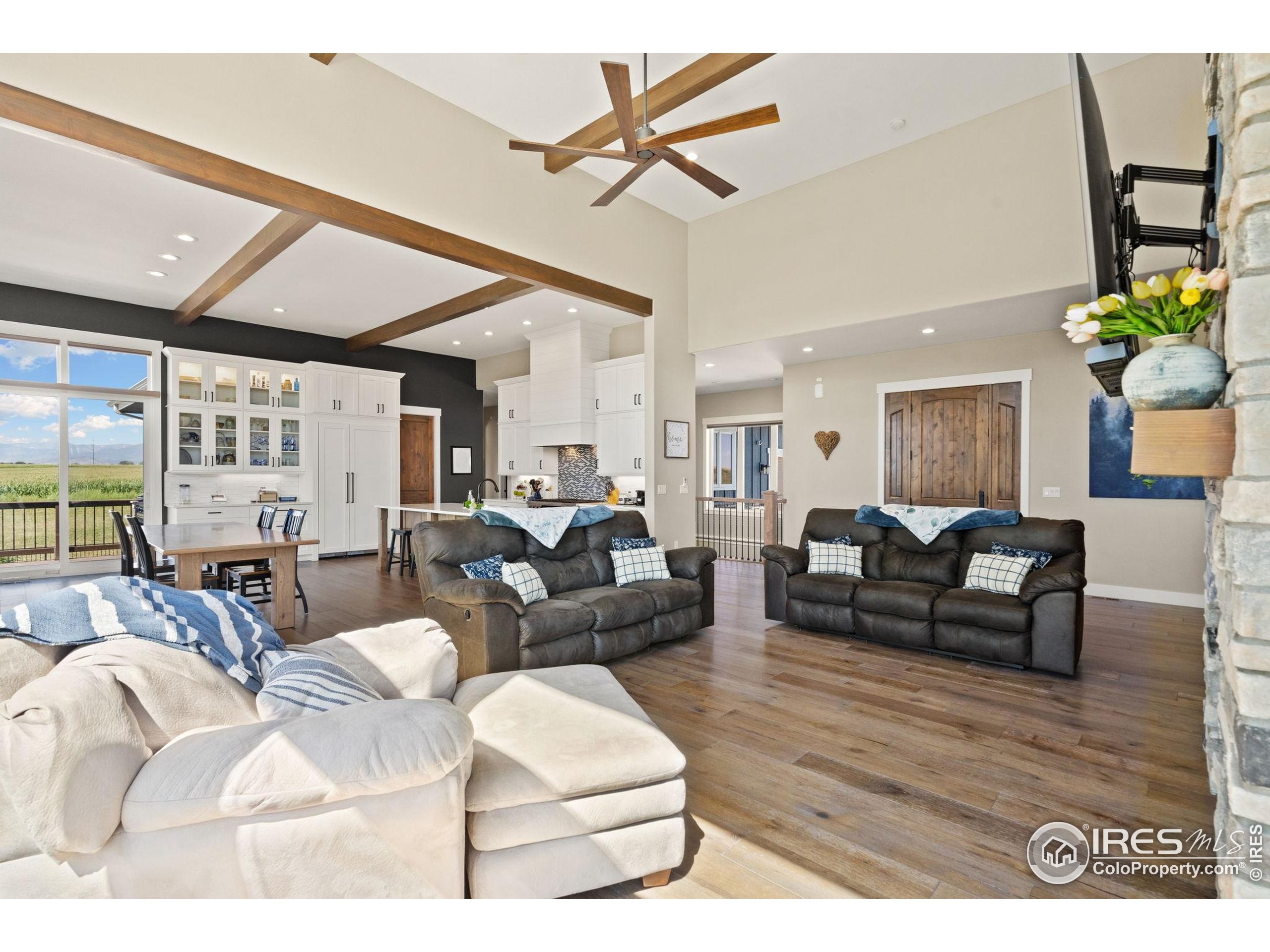 3324 Fox Crossing Place Loveland, CO 80537 - Photo 19 of 47 a living room with furniture a rug and a chandelier