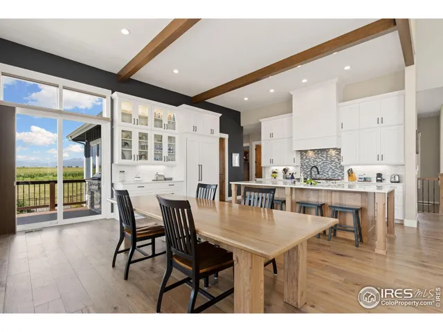a dining room with furniture window and wooden floor