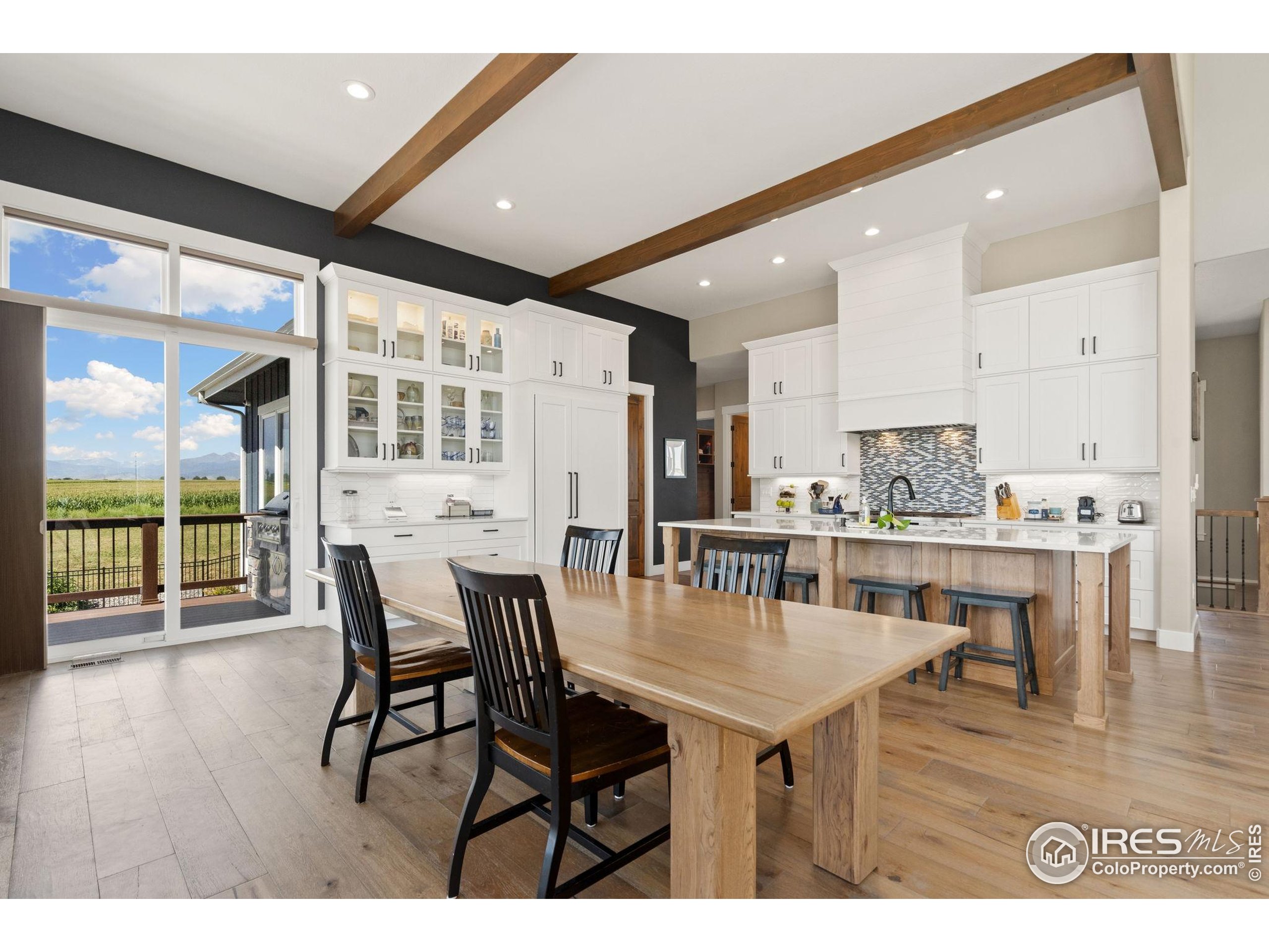 3324 Fox Crossing Place Loveland, CO 80537 - Photo 26 of 47 a dining room with furniture and wooden floor