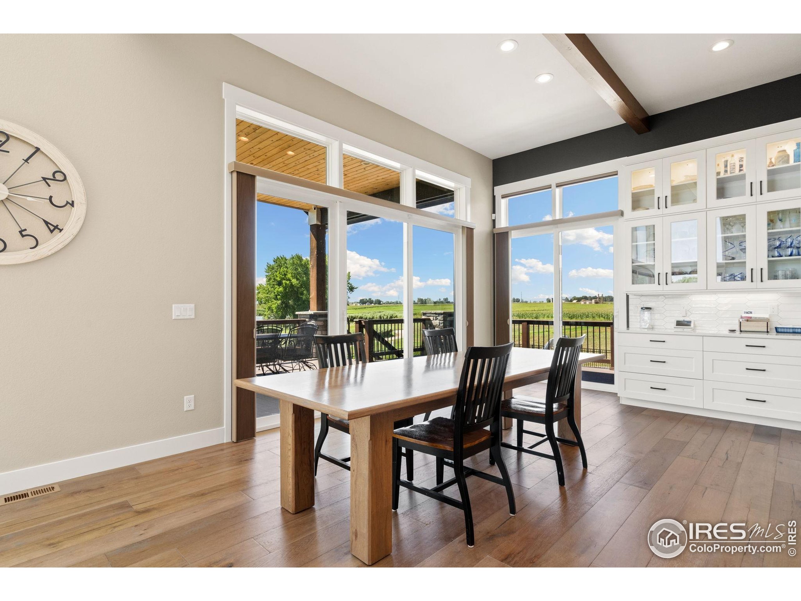 3324 Fox Crossing Place Loveland, CO 80537 - Photo 27 of 47 a dining room with furniture window and wooden floor
