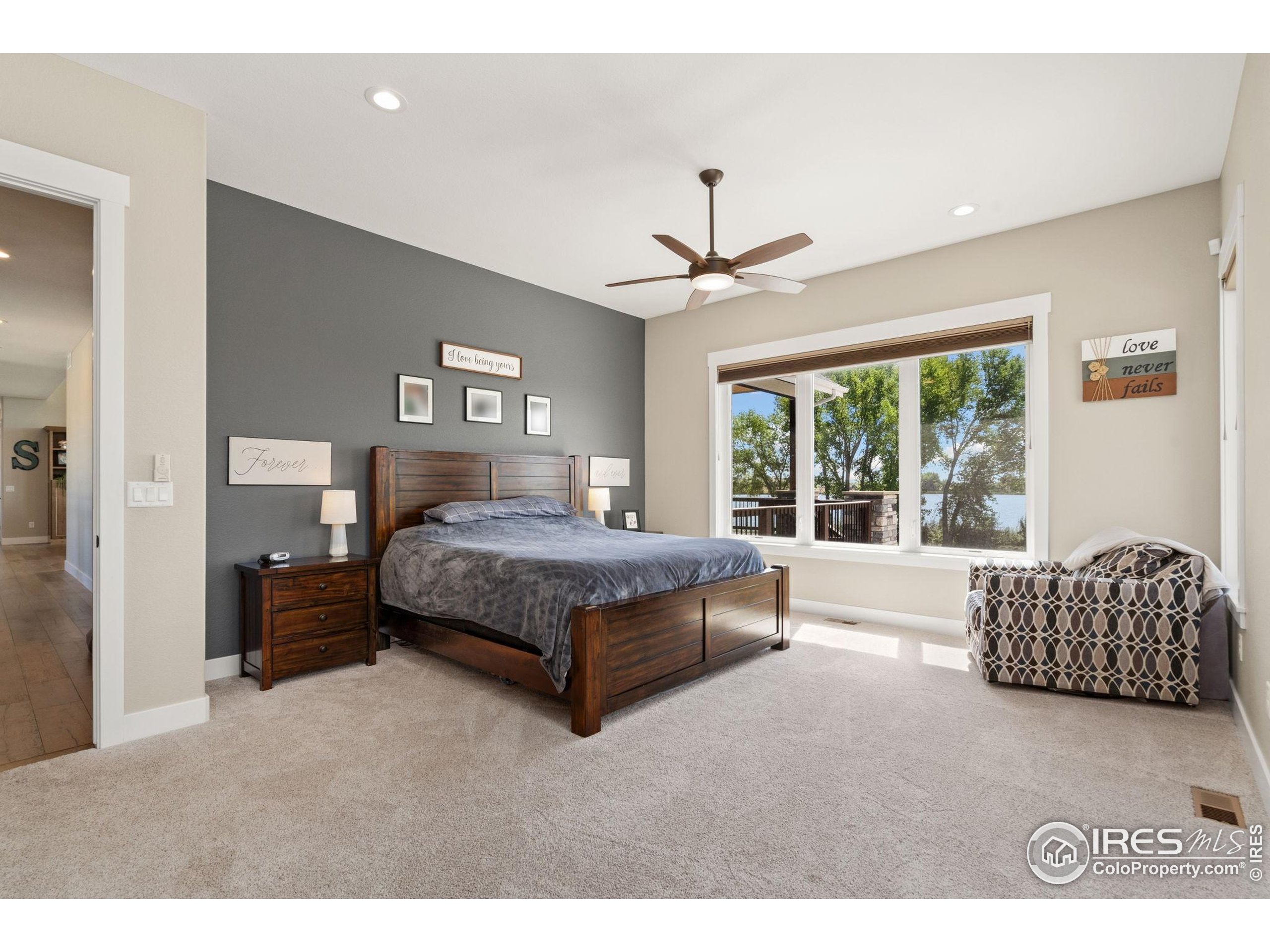 3324 Fox Crossing Place Loveland, CO 80537 - Photo 29 of 47 a spacious bedroom with a bed and a couch