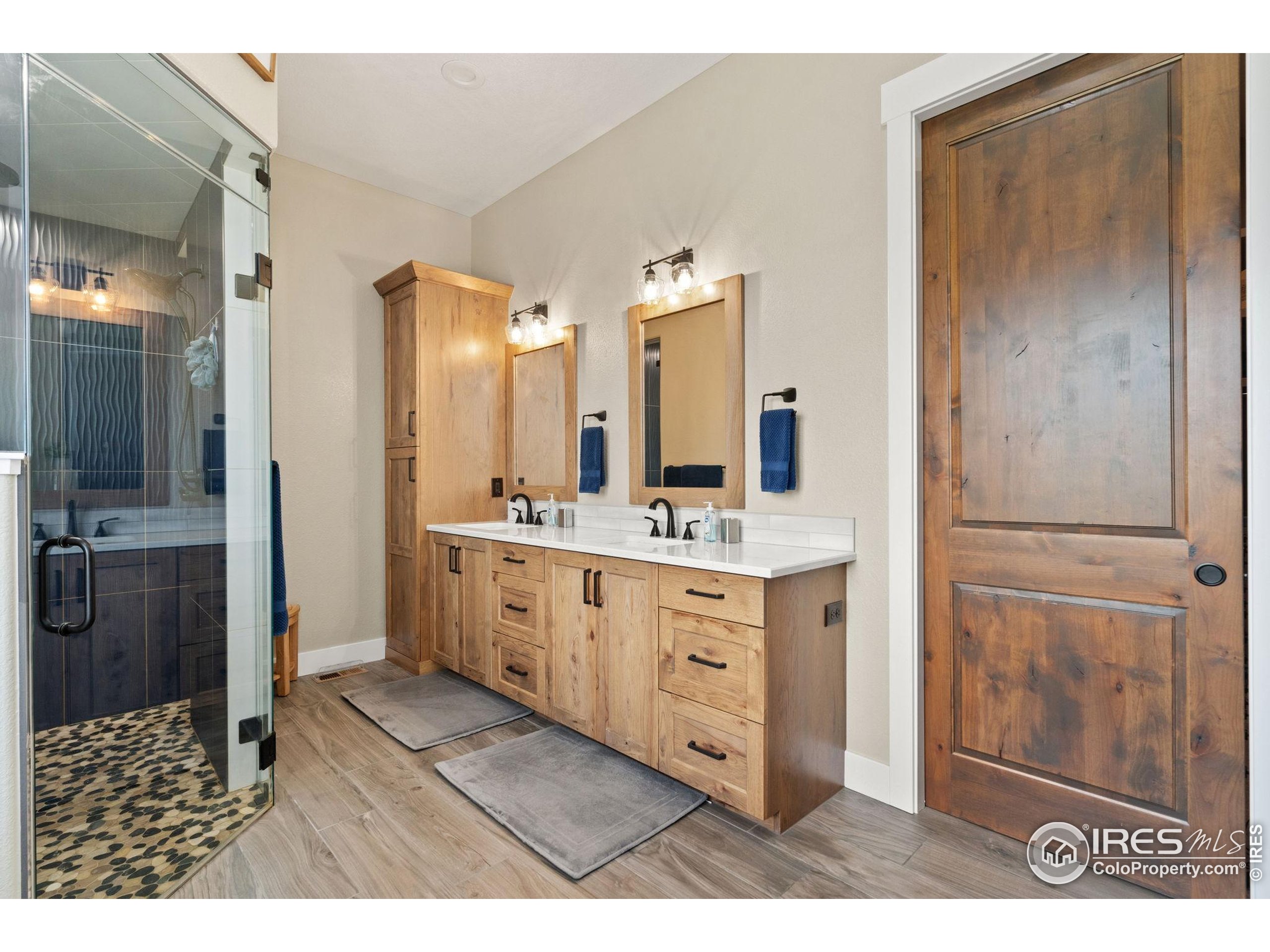 3324 Fox Crossing Place Loveland, CO 80537 - Photo 31 of 47 a bathroom with a sink a mirror and a shower