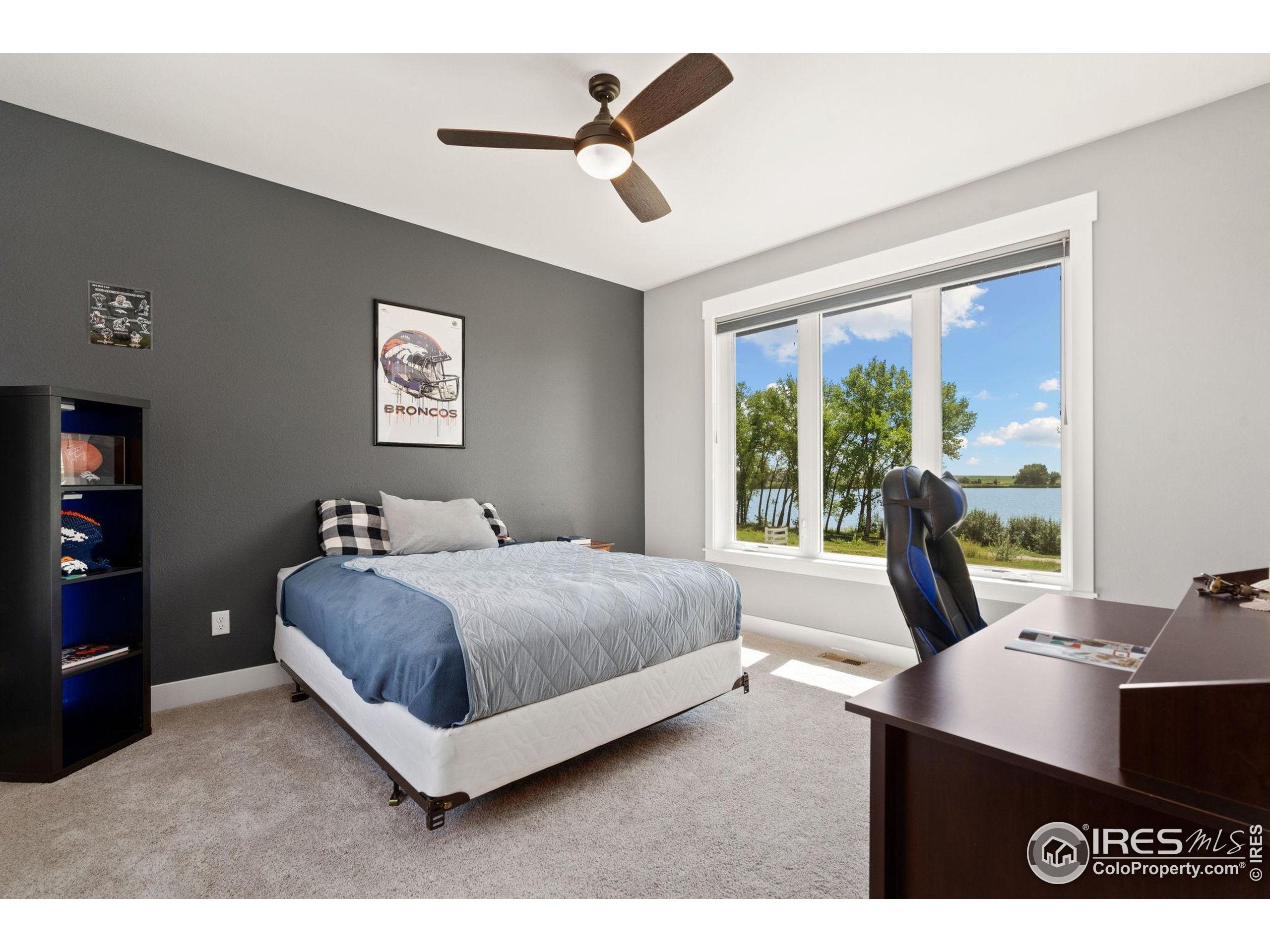 3324 Fox Crossing Place Loveland, CO 80537 - Photo 33 of 47 a living room with a bed furniture and a large window