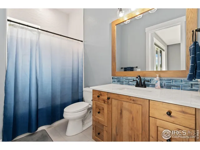 a bedroom with furniture and a large window