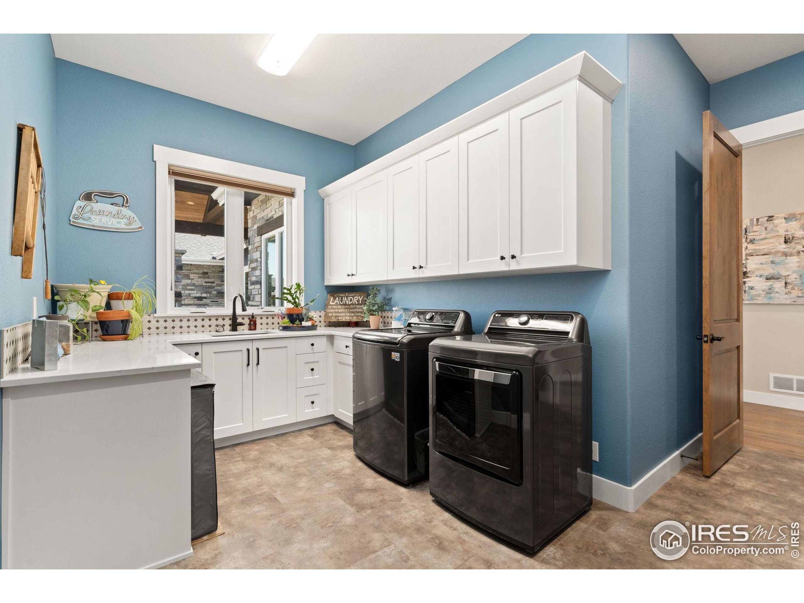 3324 Fox Crossing Place Loveland, CO 80537 - Photo 38 of 47 a kitchen with stainless steel appliances granite countertop a stove a sink and a microwave