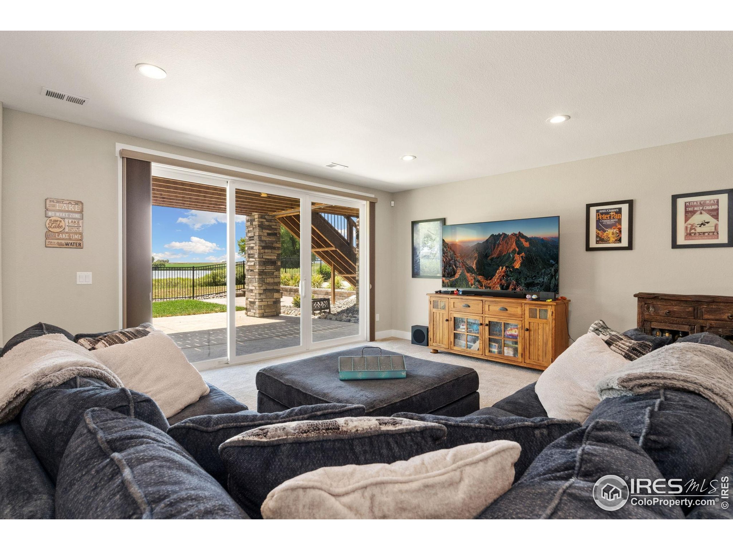 3324 Fox Crossing Place Loveland, CO 80537 - Photo 41 of 47 a living room with furniture and a flat screen tv
