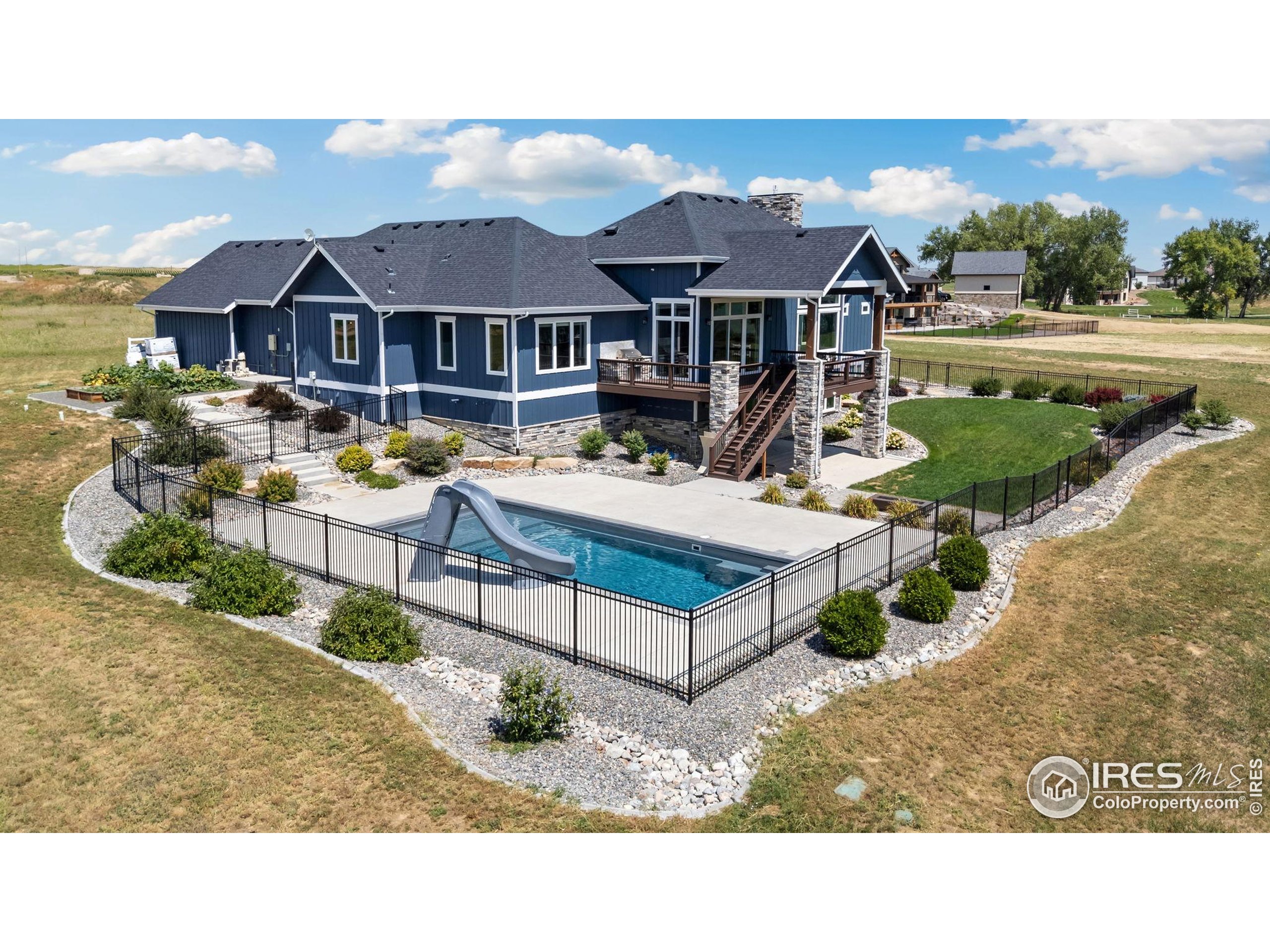 3324 Fox Crossing Place Loveland, CO 80537 - Photo 7 of 47 a aerial view of a house with swimming pool and a yard