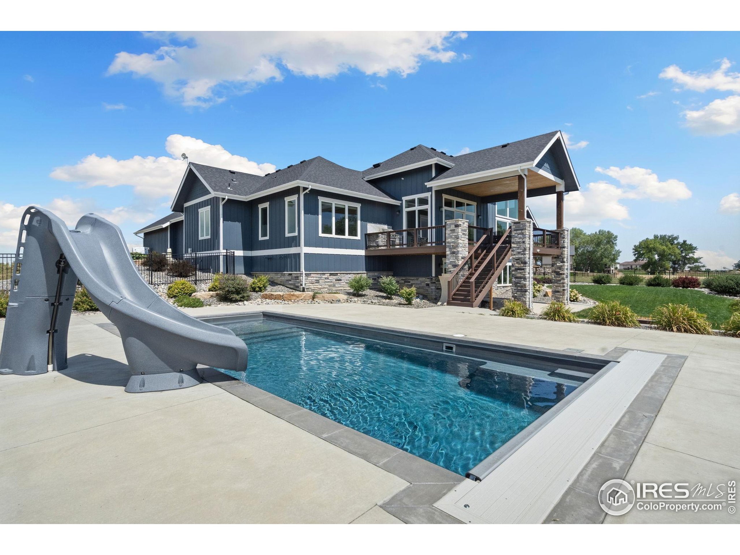 3324 Fox Crossing Place Loveland, CO 80537 - Photo 8 of 47 a view of a house with pool and chairs