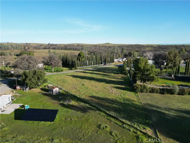 an aerial view of a golf course with trees