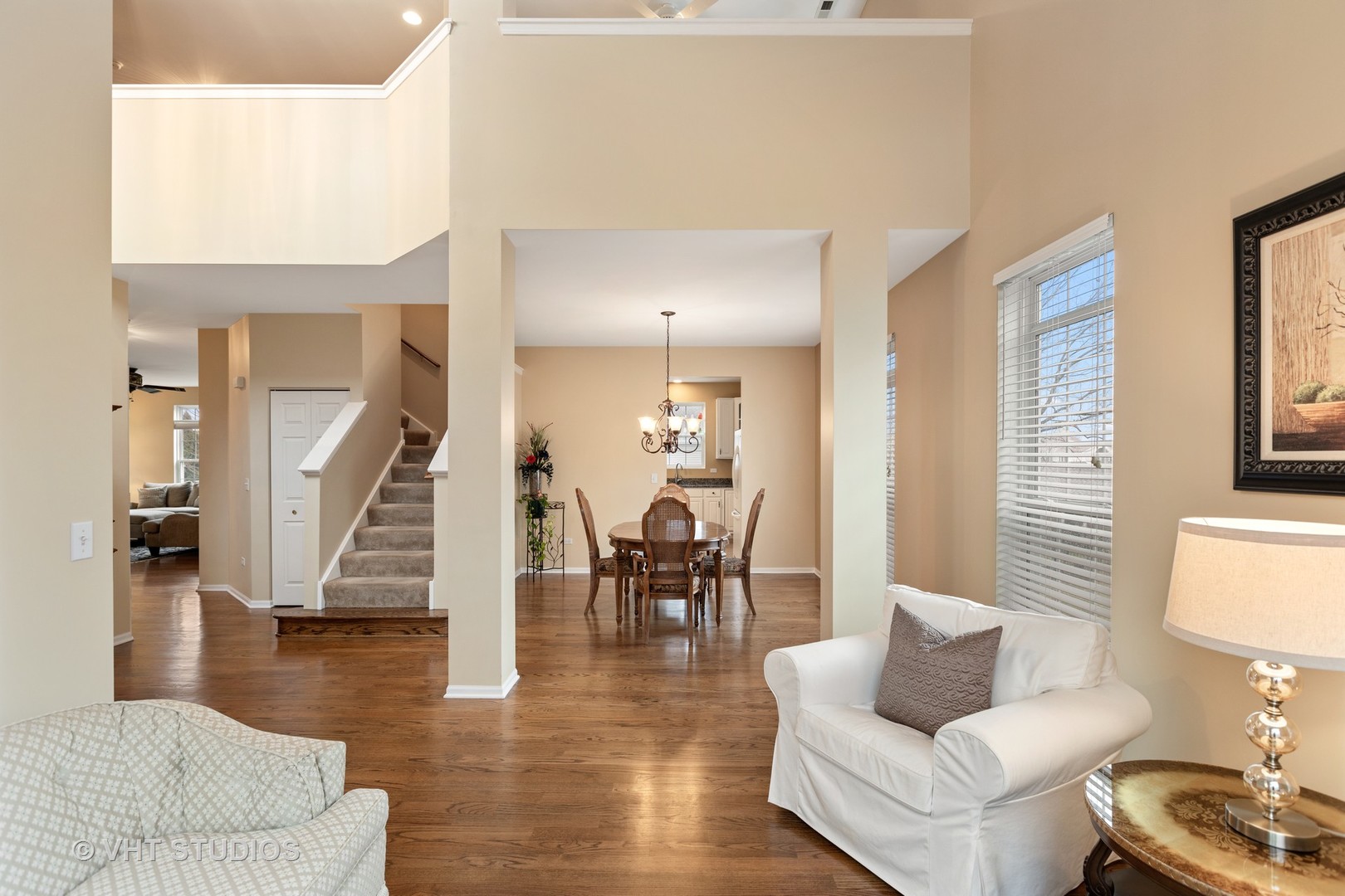 235 Stonegate Road Bolingbrook, IL 60440 - Photo 5 of 24 a living room with furniture and a dining table with wooden floor