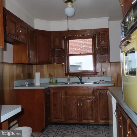 a kitchen with kitchen island granite countertop a sink cabinets and window