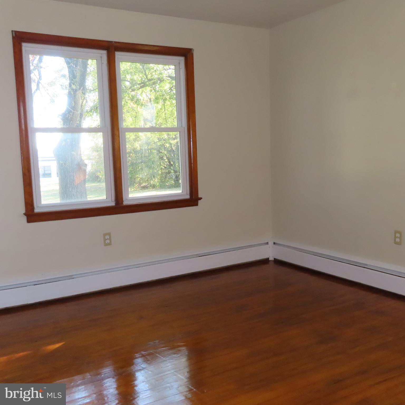 1126 Crottlestown Road Chambersburg, PA 17202 - Photo 14 of 47 a view of an empty room with wooden floor and a window