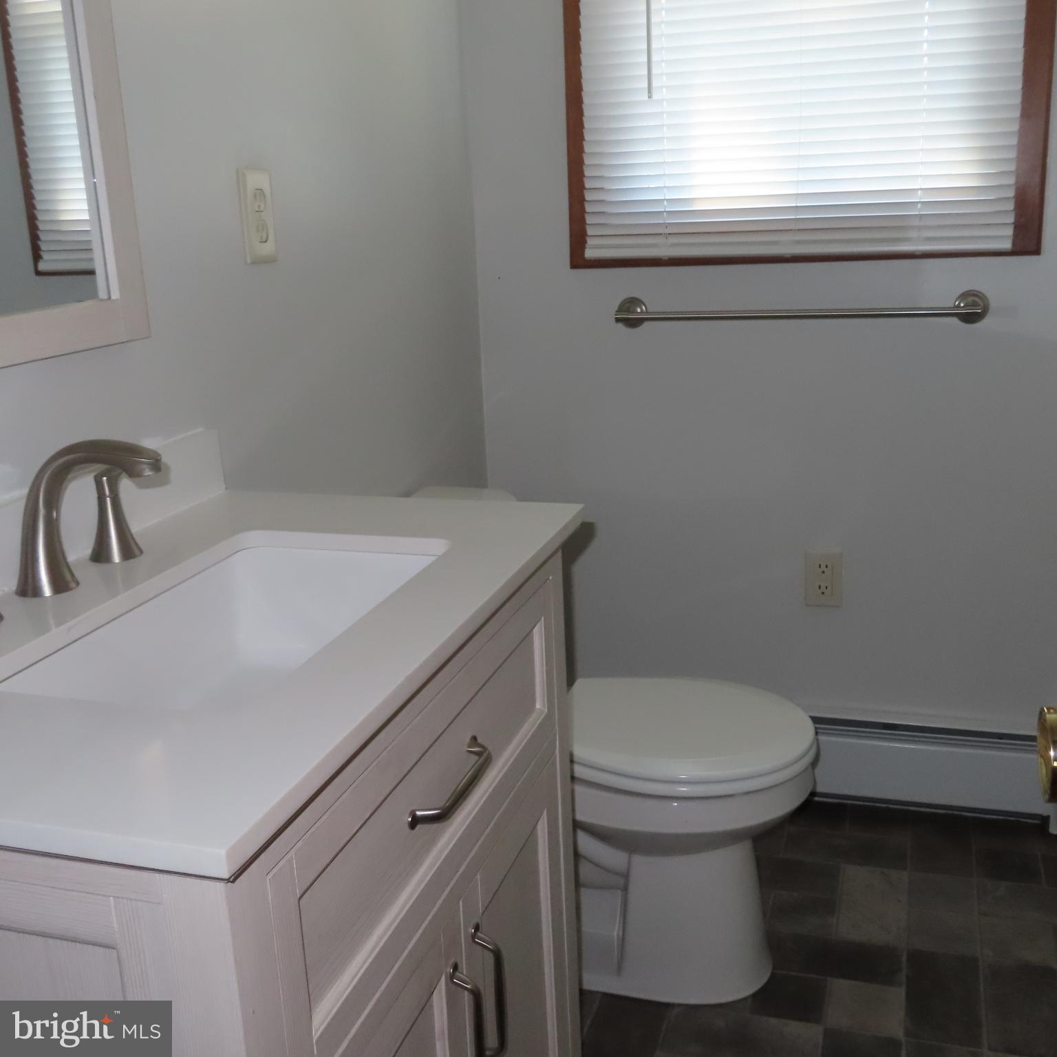 1126 Crottlestown Road Chambersburg, PA 17202 - Photo 17 of 47 a bathroom with a sink toilet and window