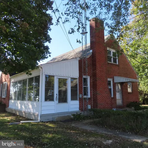 a house that has tree in front of it