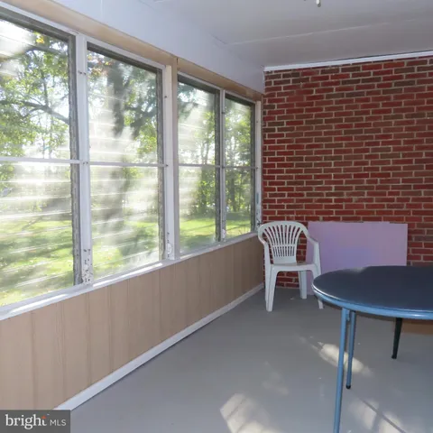 a dining room with furniture and a window