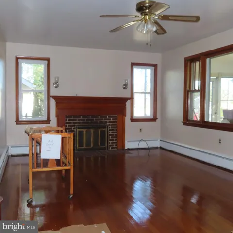 a living room with wooden floors and a fireplace