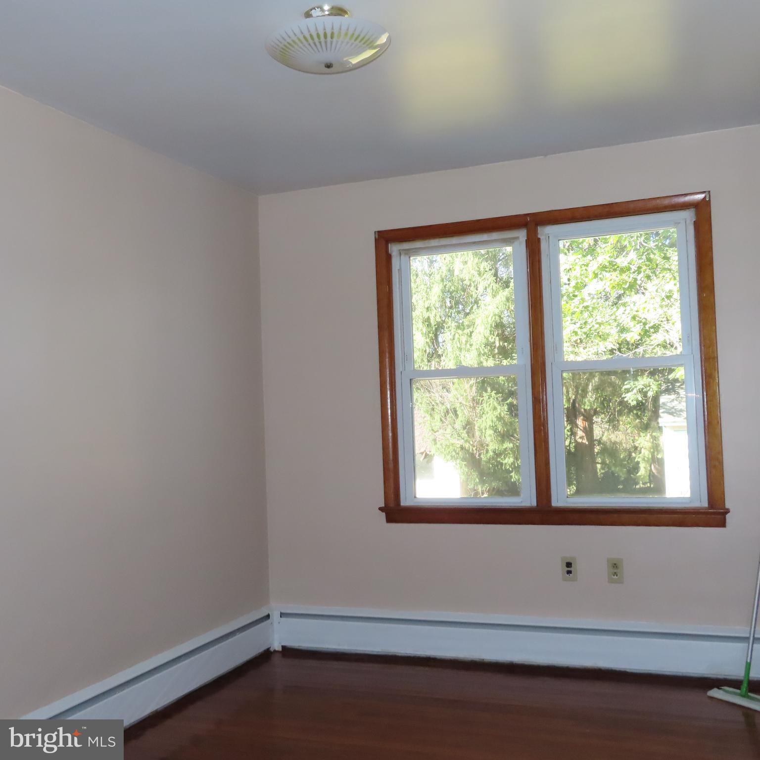 1126 Crottlestown Road Chambersburg, PA 17202 - Photo 9 of 47 a view of an empty room with wooden floor and a window