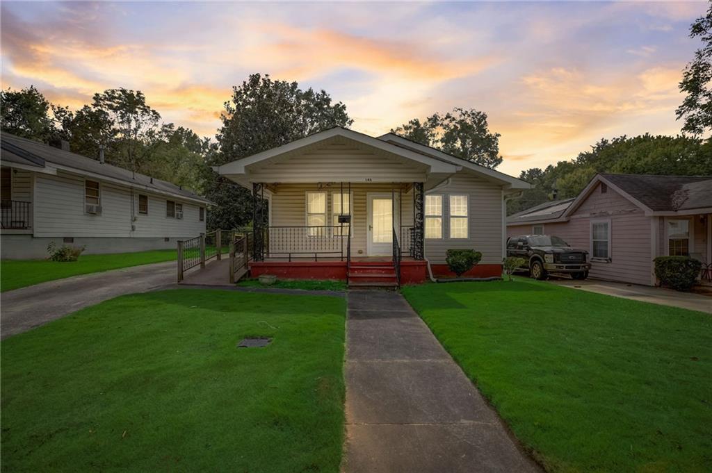 146 Spring Street Newnan, GA 30263 - Photo 1 of 1 a front view of house with yard and green space