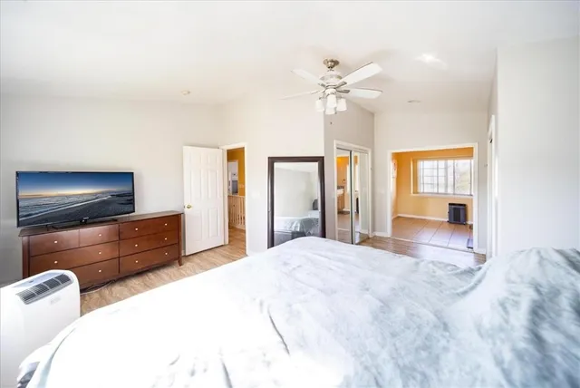 a bedroom with a bed and wooden floor