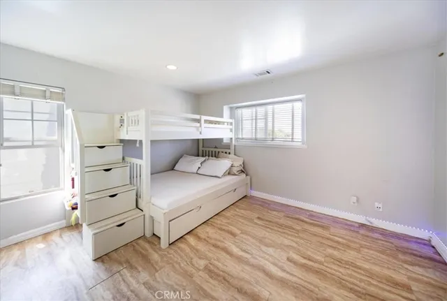 a bedroom with furniture and a large window
