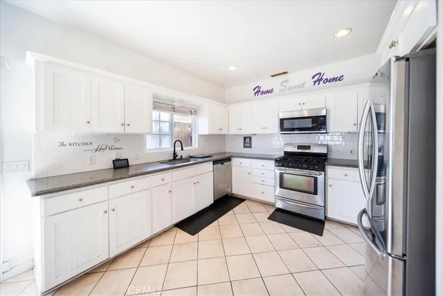 a open kitchen with granite countertop a sink cabinets and counter space