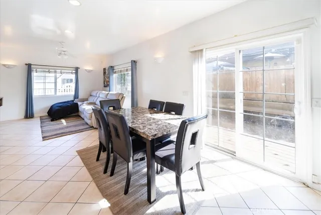 a living room with furniture and a view of kitchen