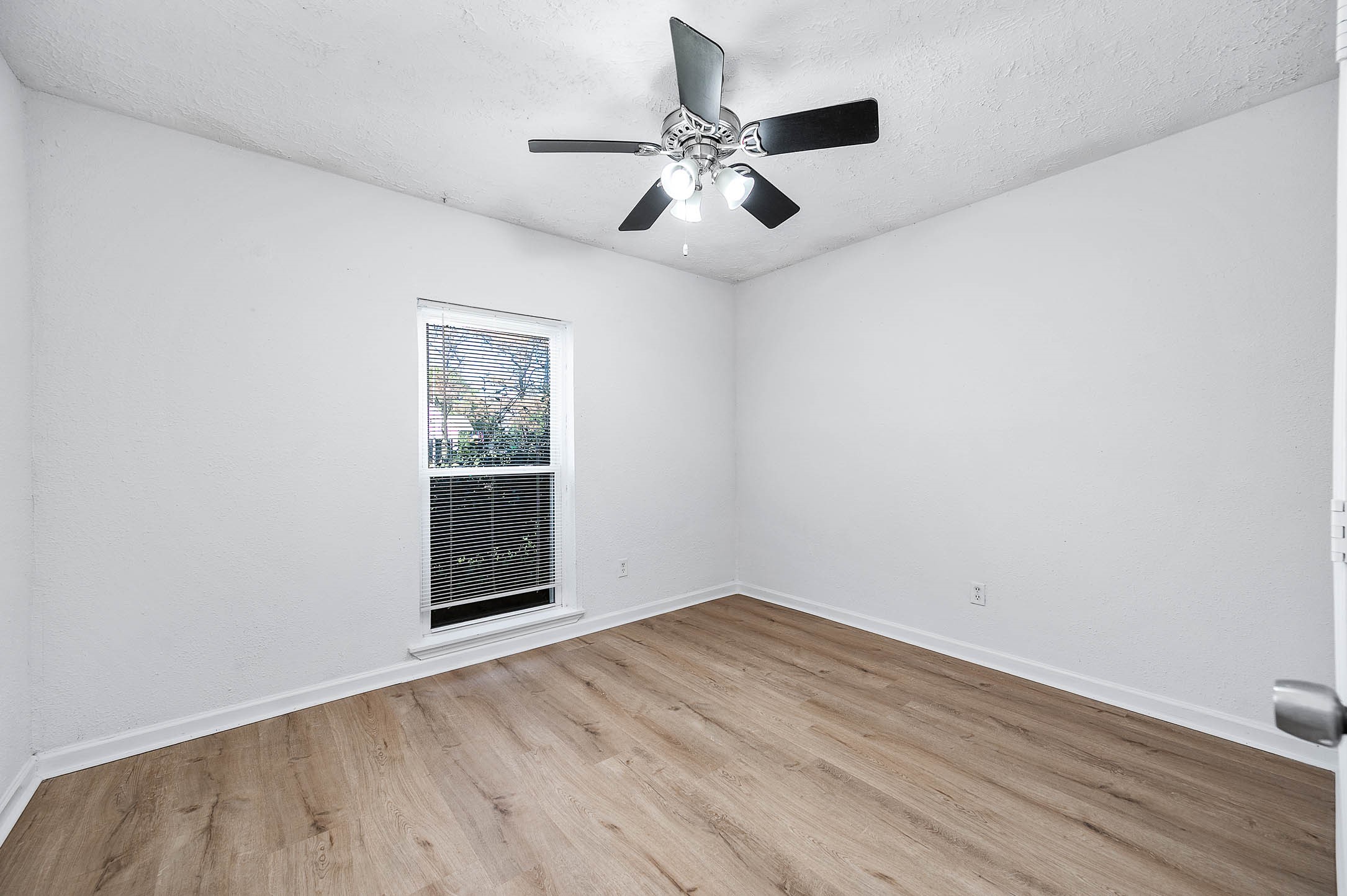 24007 Pepperrell Pl Street Katy, TX 77493 - Photo 16 of 24 an empty room with wooden floor chandelier fan and windows