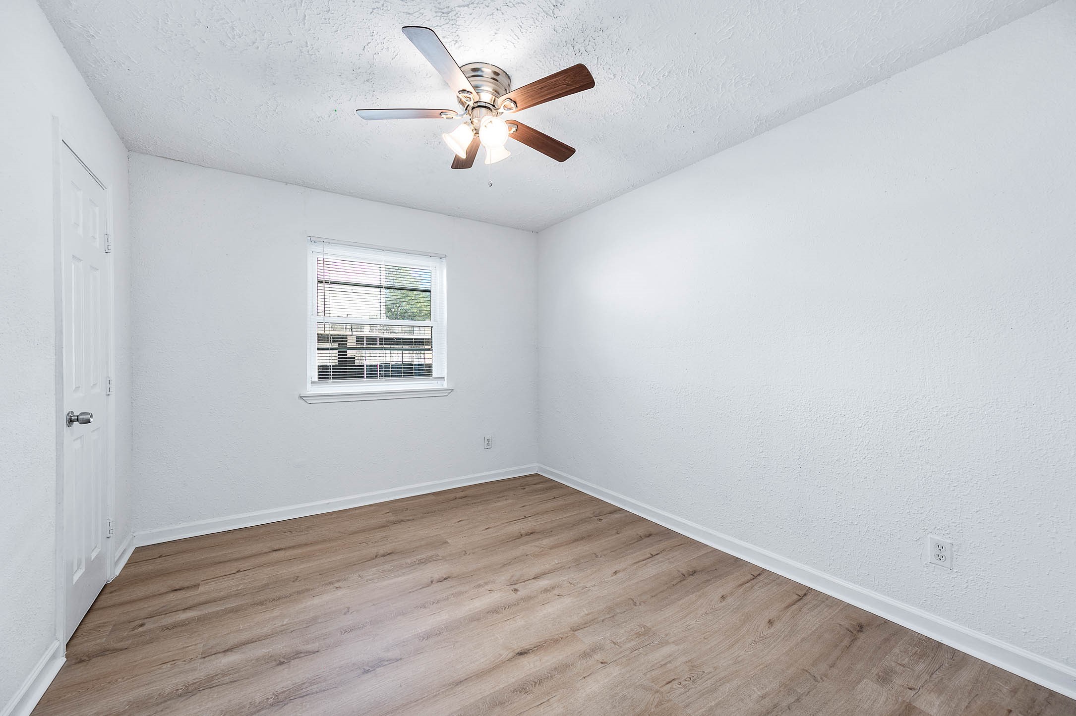 24007 Pepperrell Pl Street Katy, TX 77493 - Photo 18 of 24 an empty room with wooden floor and windows