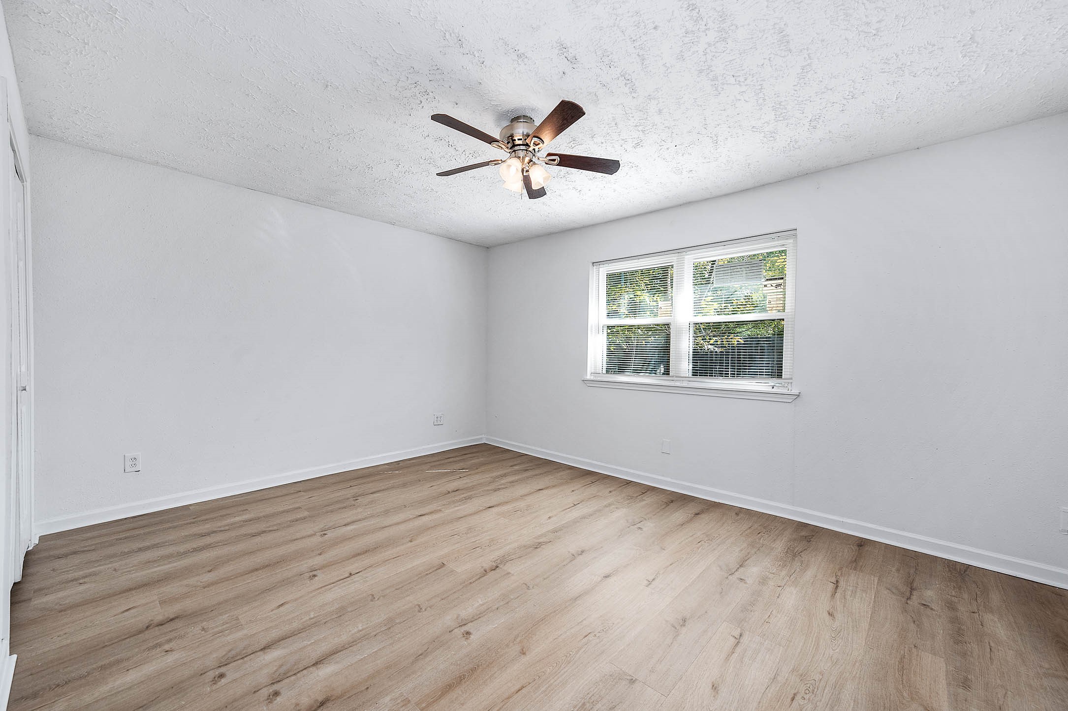 24007 Pepperrell Pl Street Katy, TX 77493 - Photo 19 of 24 an empty room with wooden floor ceiling fan and windows