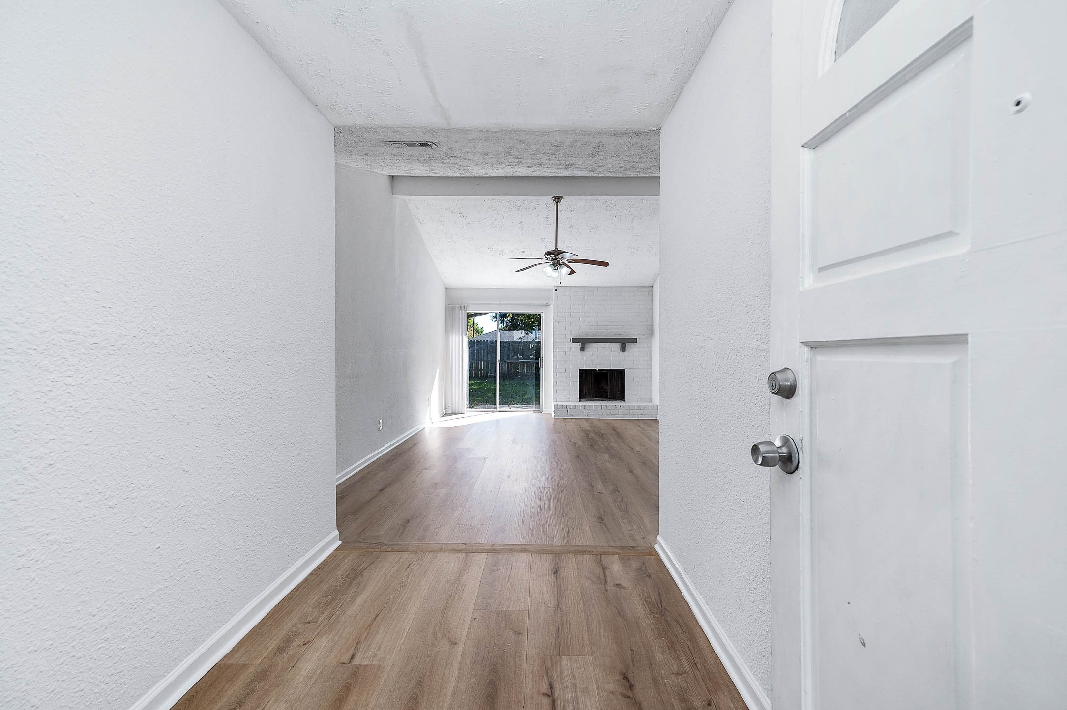 24007 Pepperrell Pl Street Katy, TX 77493 - Photo 5 of 24 a view of a hallway with wooden floor and a fireplace