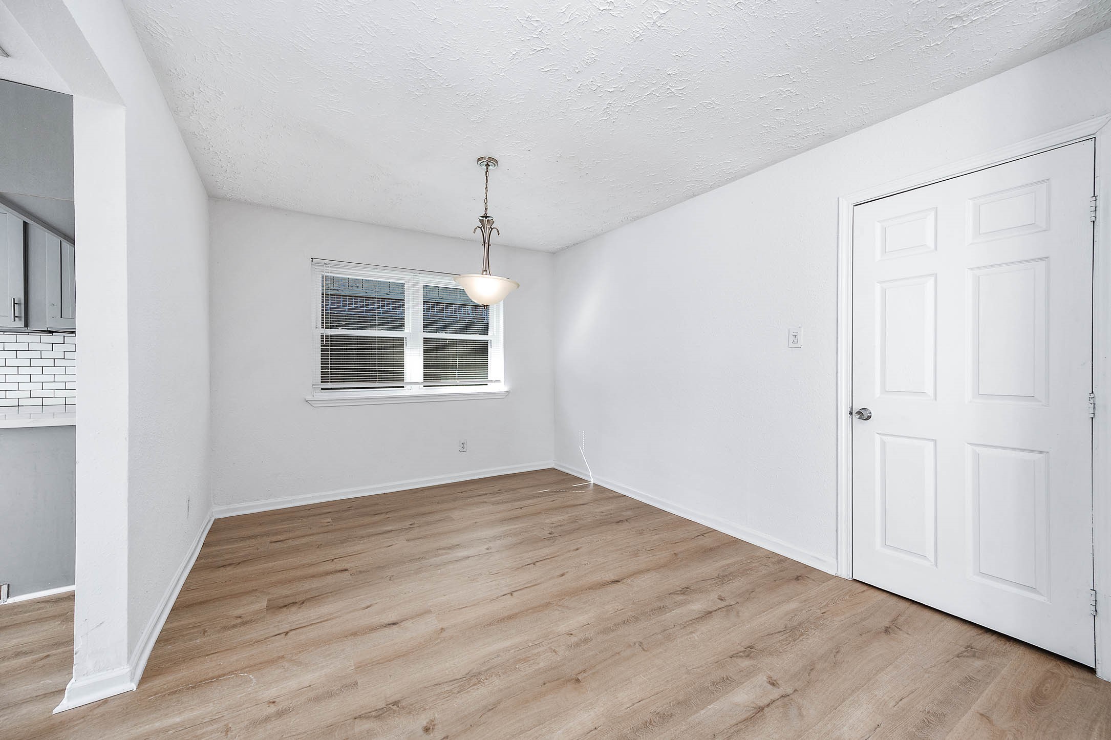 24007 Pepperrell Pl Street Katy, TX 77493 - Photo 9 of 24 an empty room with wooden floor cabinet and windows