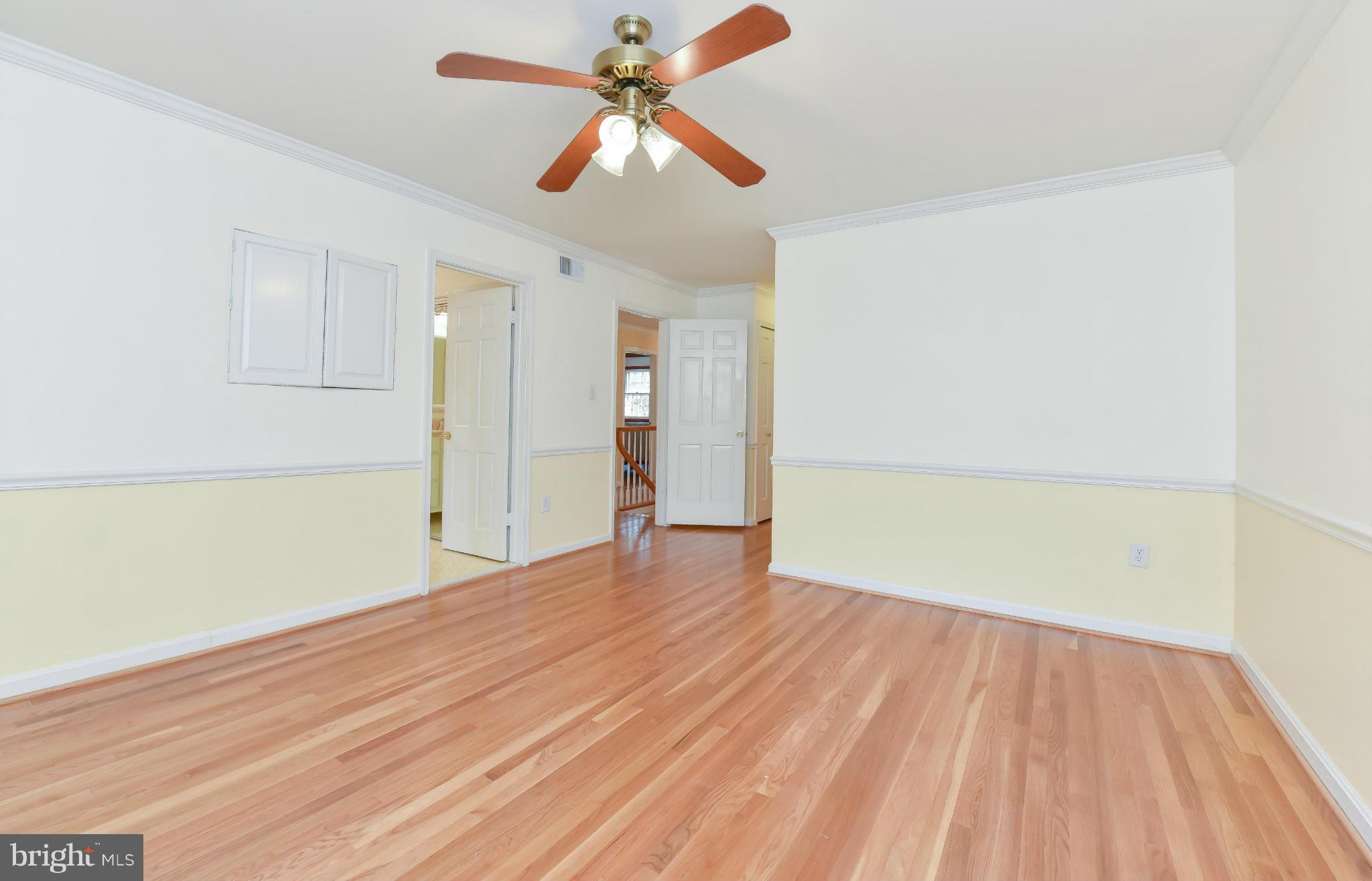 7704 Burford Drive McLean, VA 22102 - Photo 21 of 30 an empty room with wooden floor fan and windows