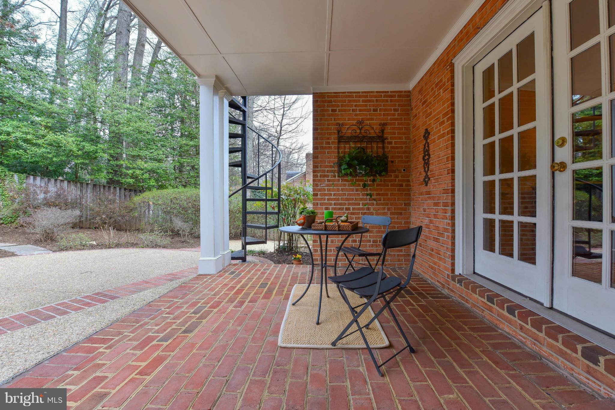 7704 Burford Drive McLean, VA 22102 - Photo 25 of 30 a patio with table and chairs and potted plants