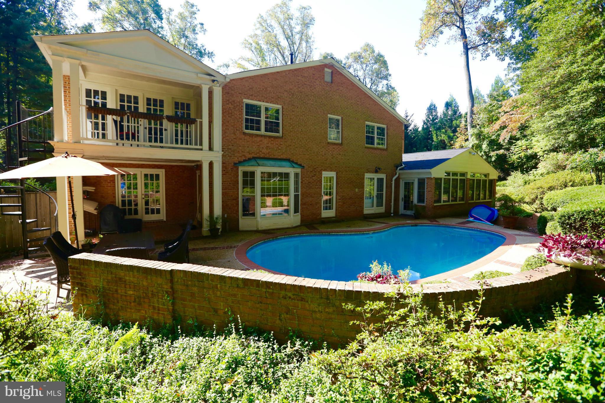 7704 Burford Drive McLean, VA 22102 - Photo 27 of 30 a view of house with a yard and swimming pool
