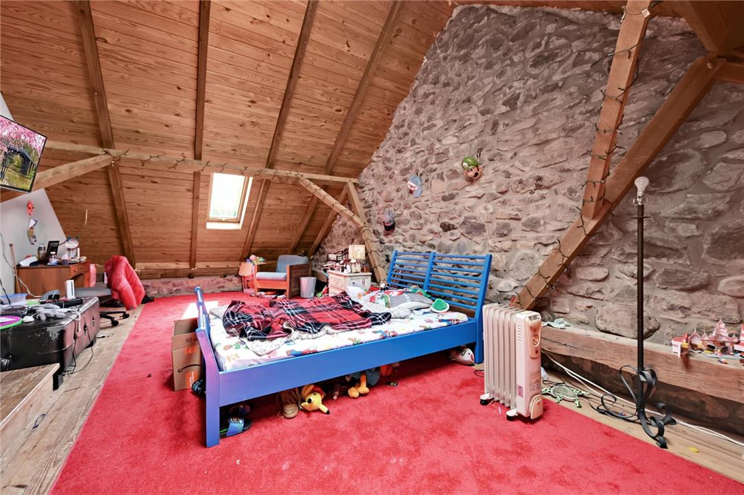 101 Conrad Road Fleetwood, PA 19522 - Photo 16 of 42 An inviting attic retreat featuring vaulted wood ceilings and exposed stone walls.