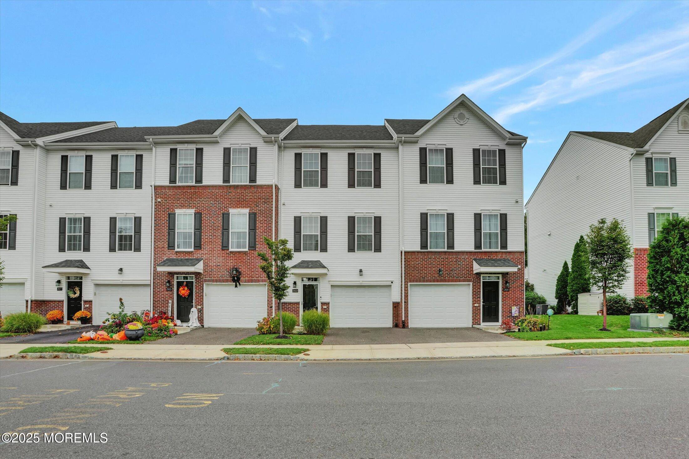 front view of multiple house with a yard
