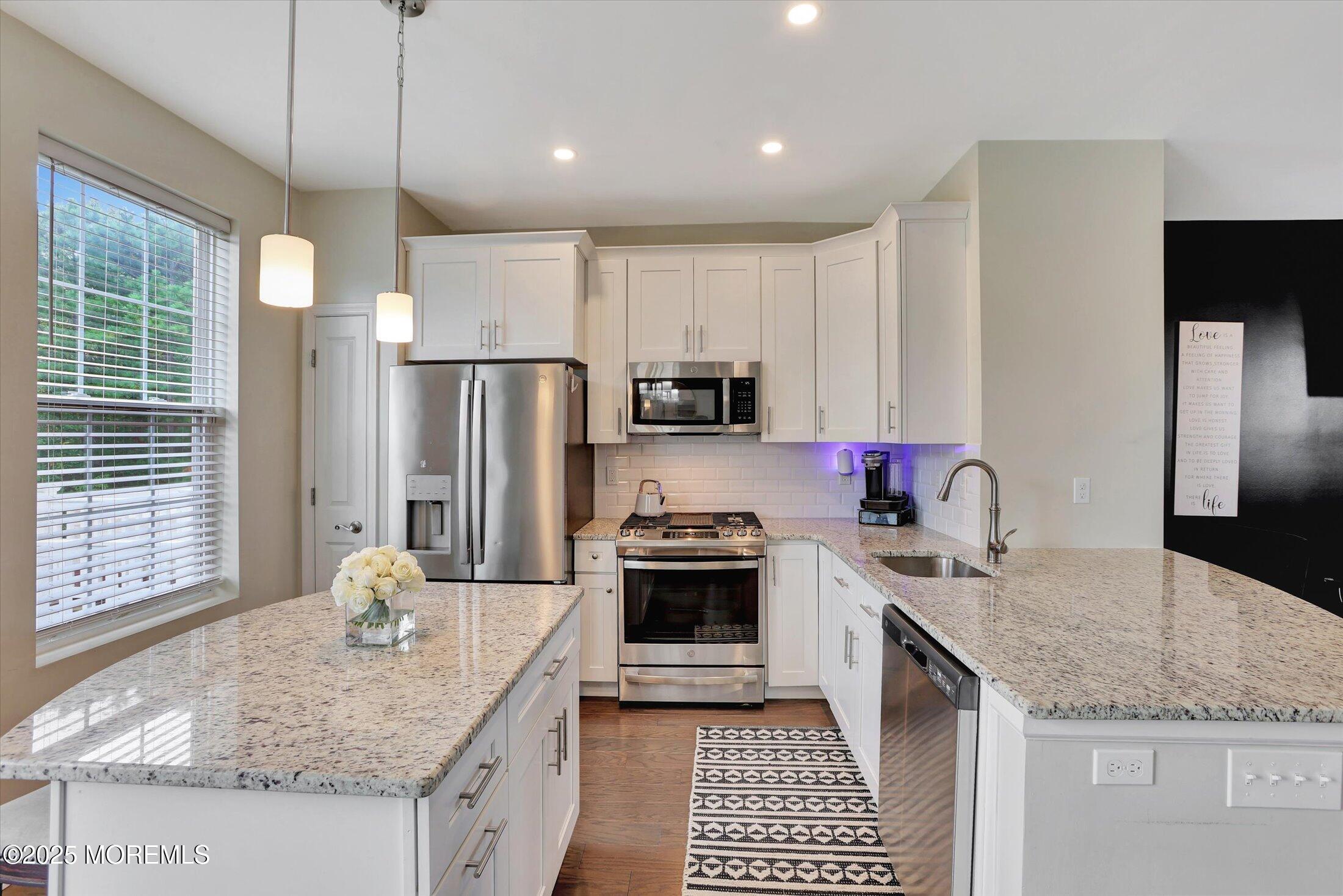 303 Prosper Way, Unit 203 Brick, NJ 08723 - Photo 12 of 36 a kitchen with stainless steel appliances granite countertop a sink stove and refrigerator