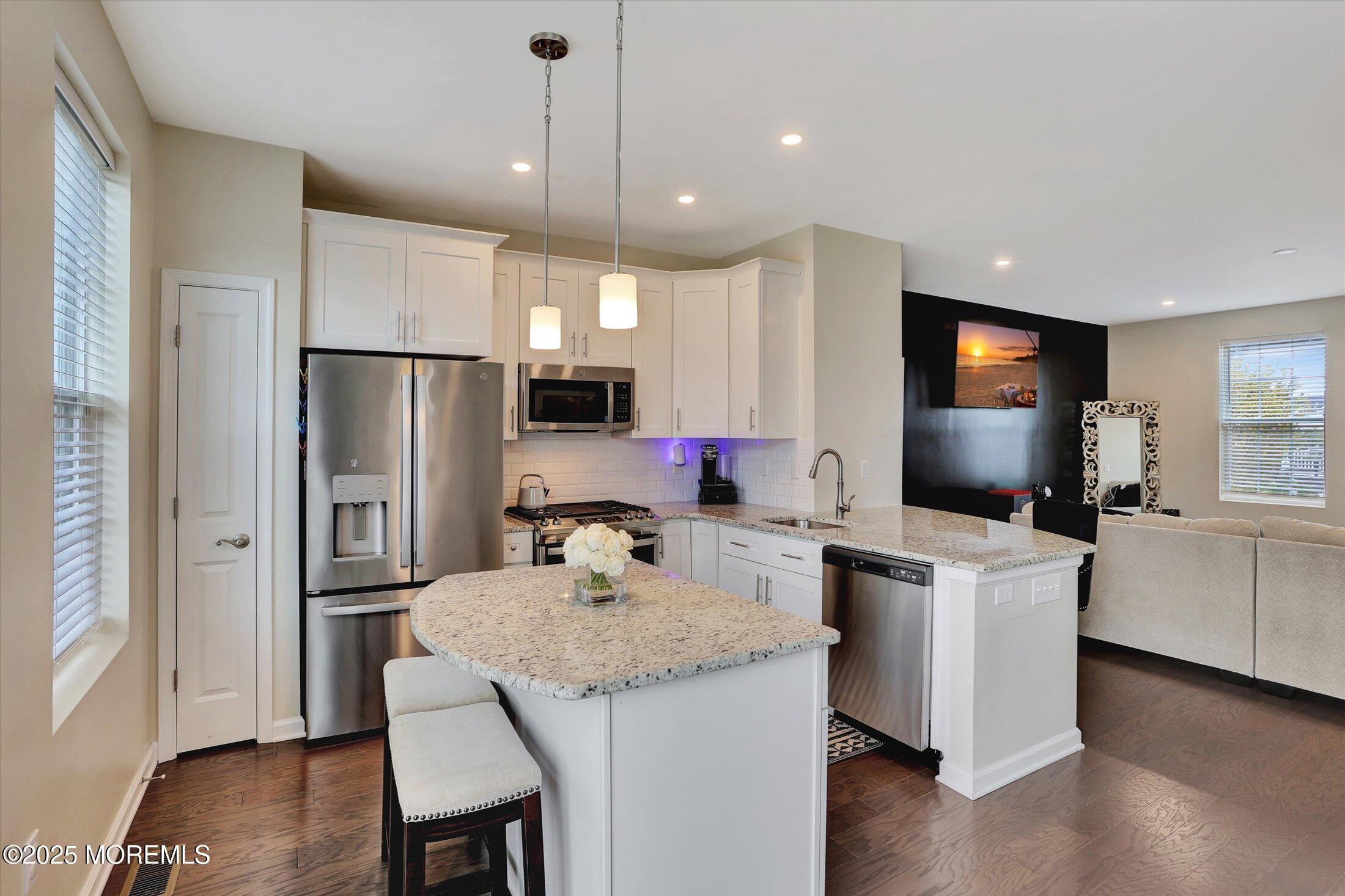 303 Prosper Way, Unit 203 Brick, NJ 08723 - Photo 13 of 36 a kitchen with refrigerator and microwave