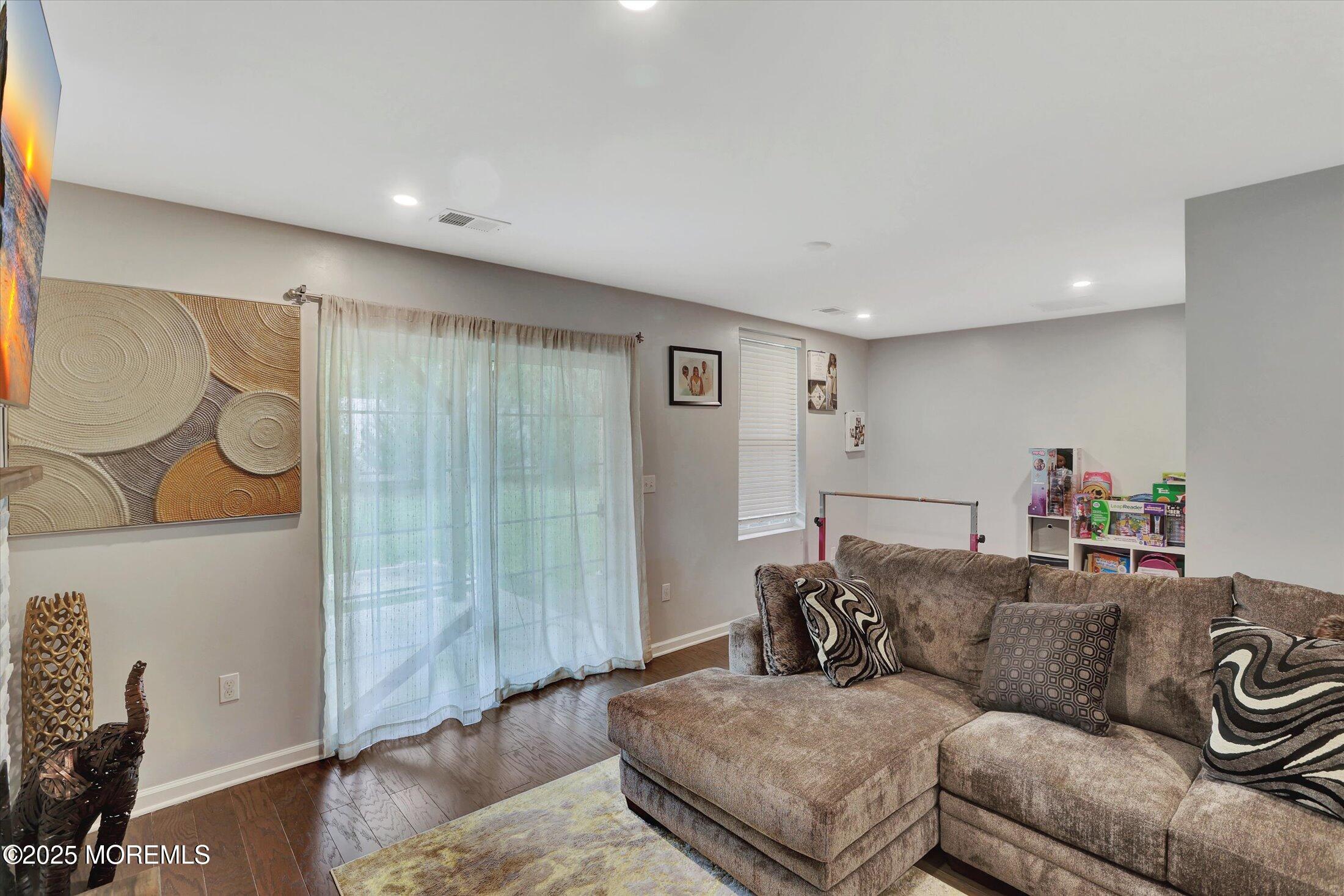 303 Prosper Way, Unit 203 Brick, NJ 08723 - Photo 2 of 36 a living room with furniture and a wooden floor