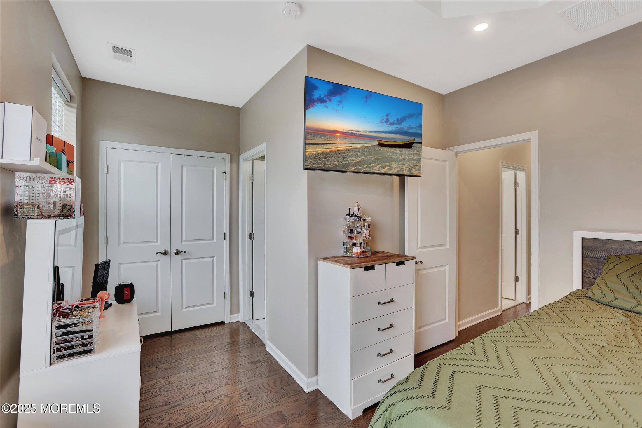 303 Prosper Way, Unit 203 Brick, NJ 08723 - Photo 21 of 36 a view of a bedroom with wooden floor