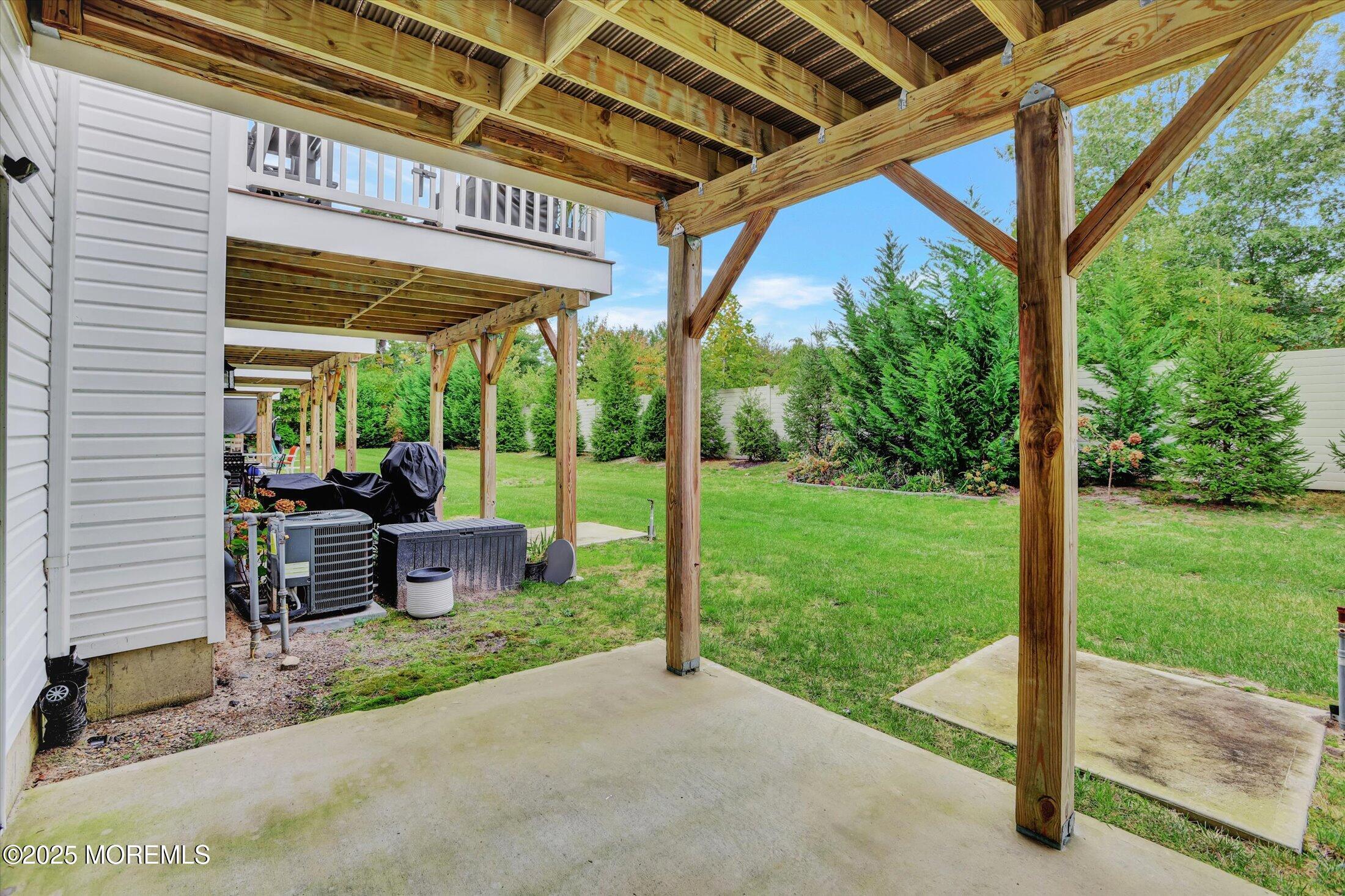 303 Prosper Way, Unit 203 Brick, NJ 08723 - Photo 29 of 36 a view of a patio with a table chairs and a backyard