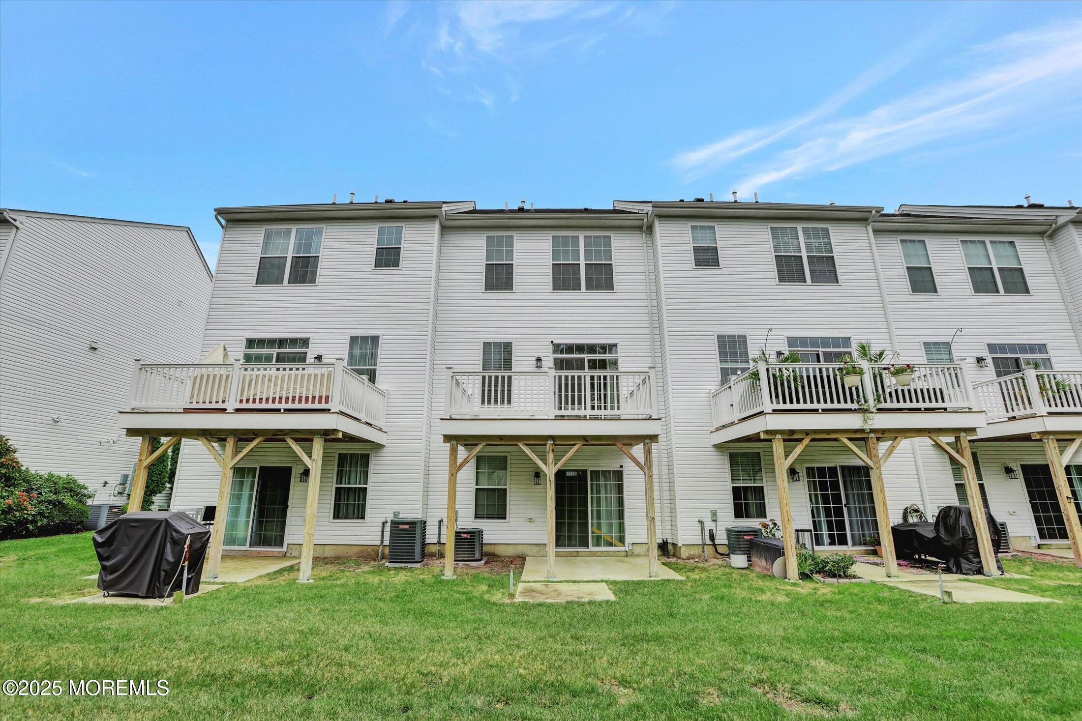 303 Prosper Way, Unit 203 Brick, NJ 08723 - Photo 31 of 36 a front view of a house with a yard