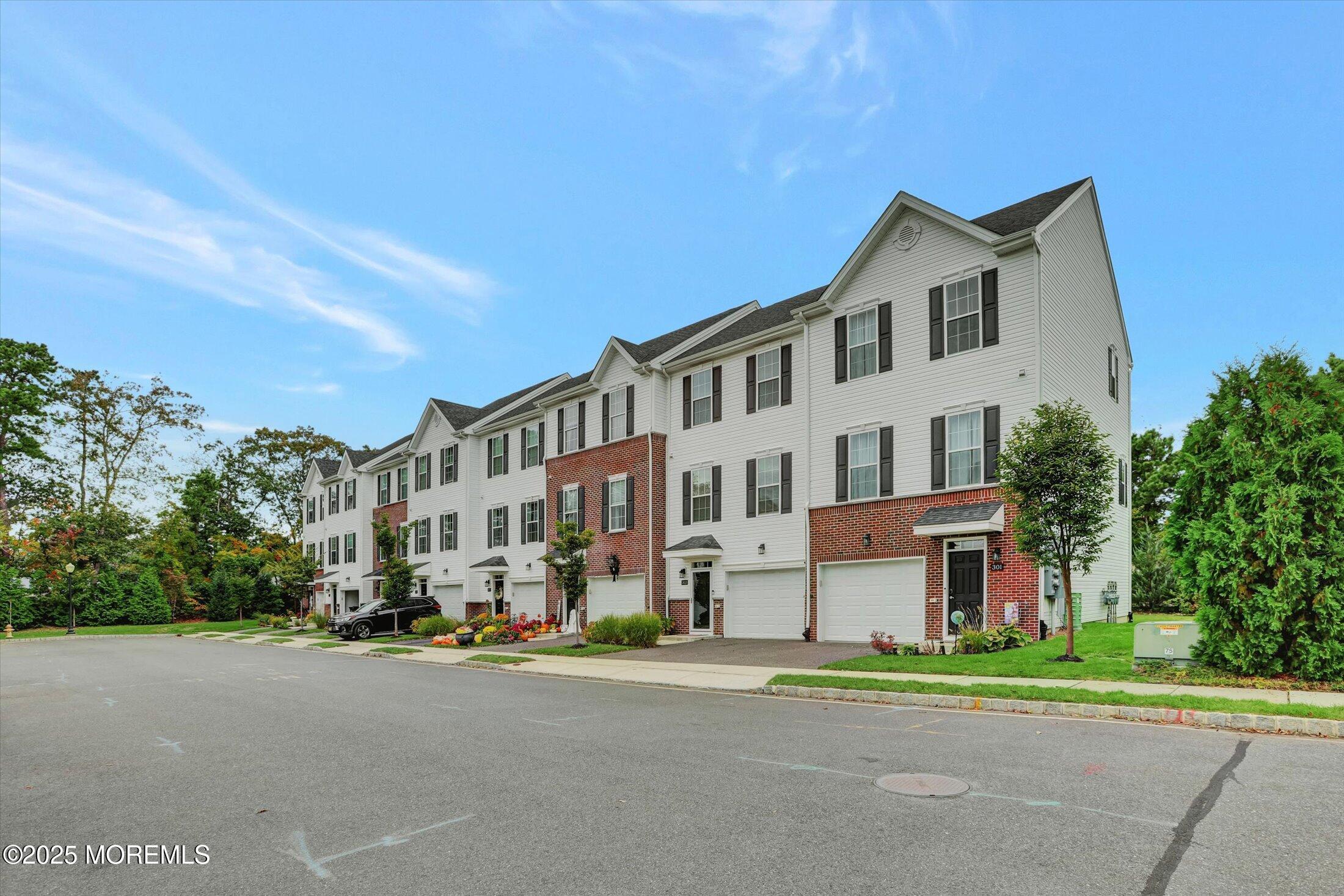 303 Prosper Way, Unit 203 Brick, NJ 08723 - Photo 35 of 36 a city street lined with buildings and trees