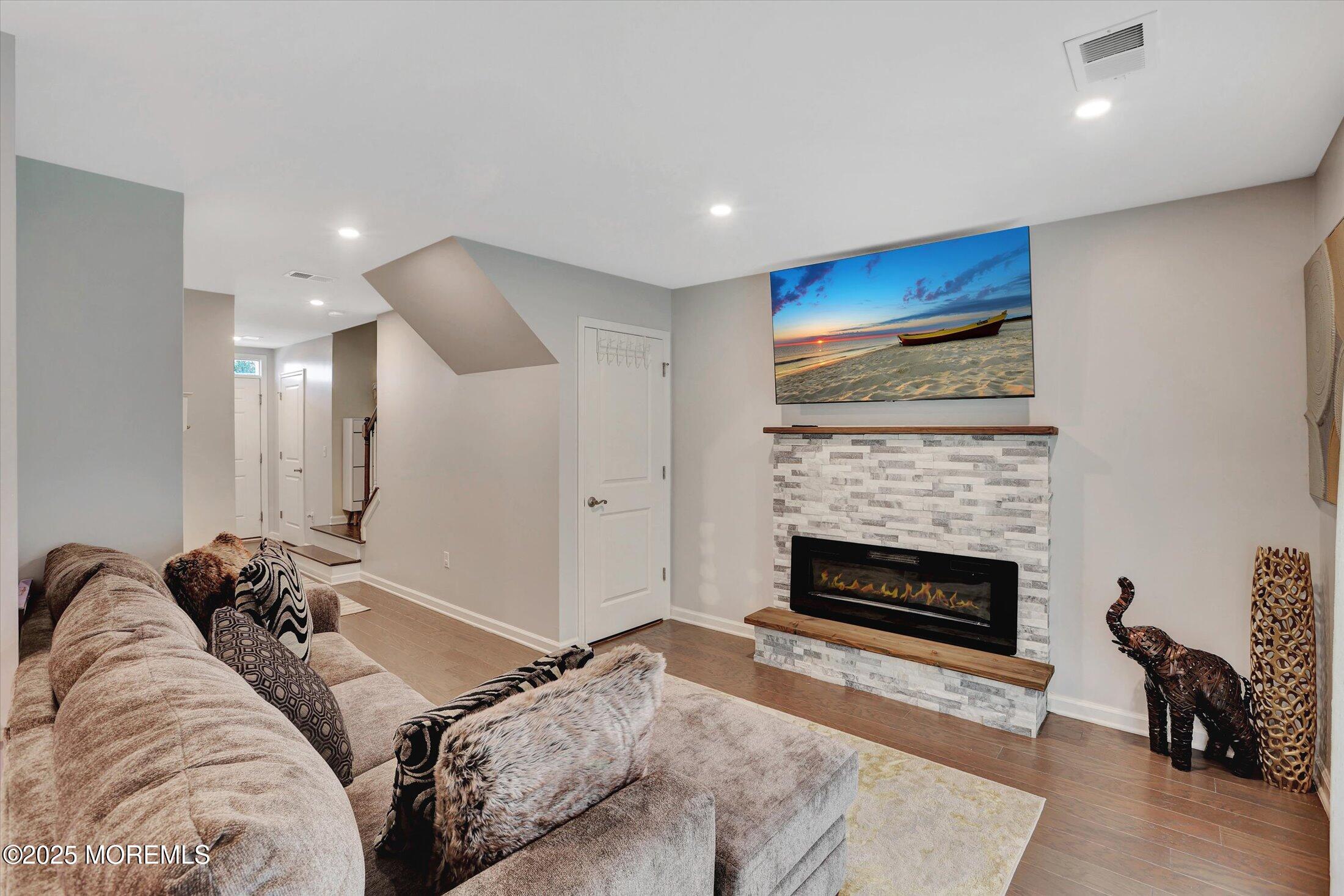 303 Prosper Way, Unit 203 Brick, NJ 08723 - Photo 4 of 36 a living room with furniture fireplace and flat screen tv