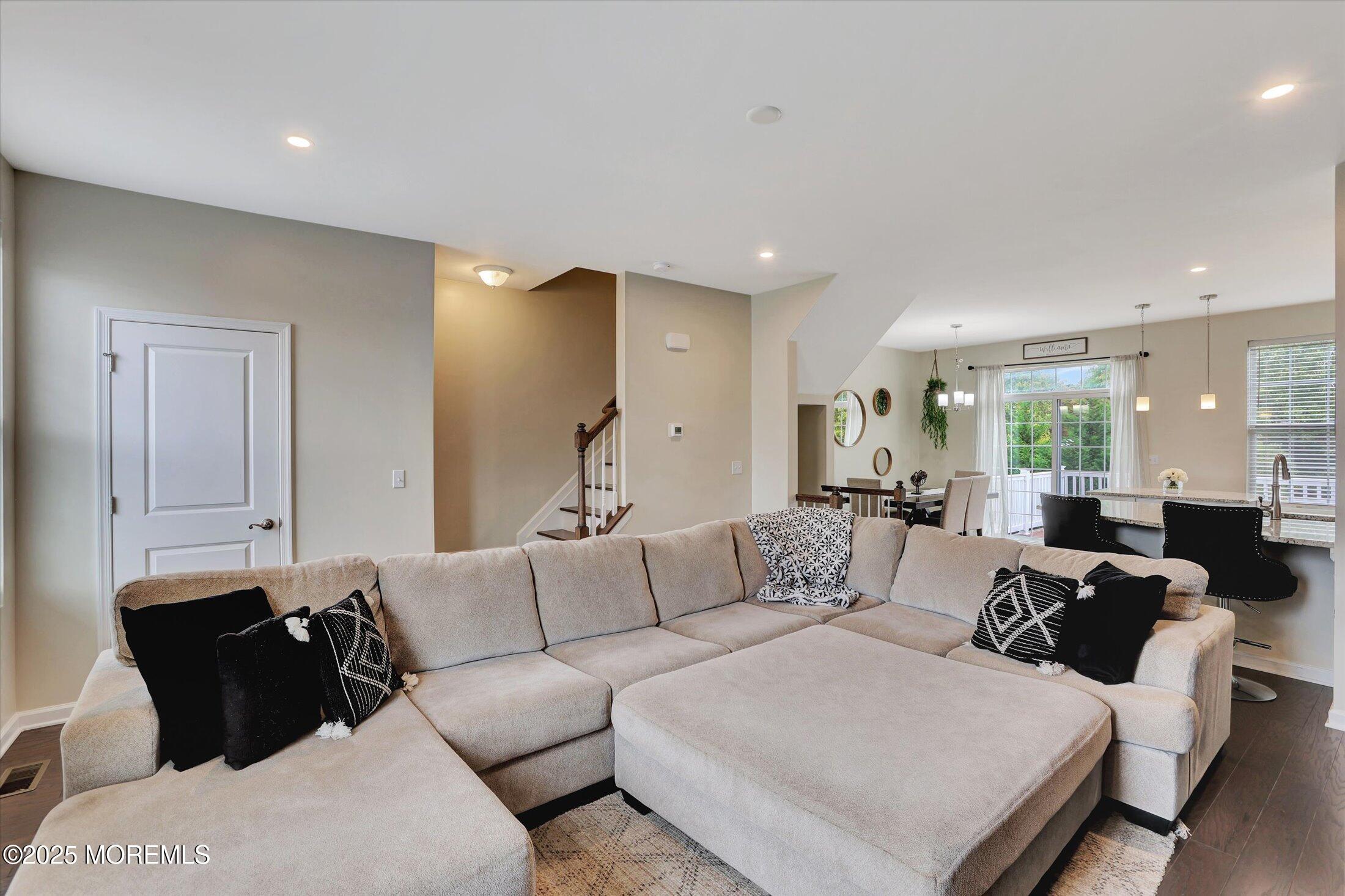 303 Prosper Way, Unit 203 Brick, NJ 08723 - Photo 8 of 36 a living room with furniture and a large mirror