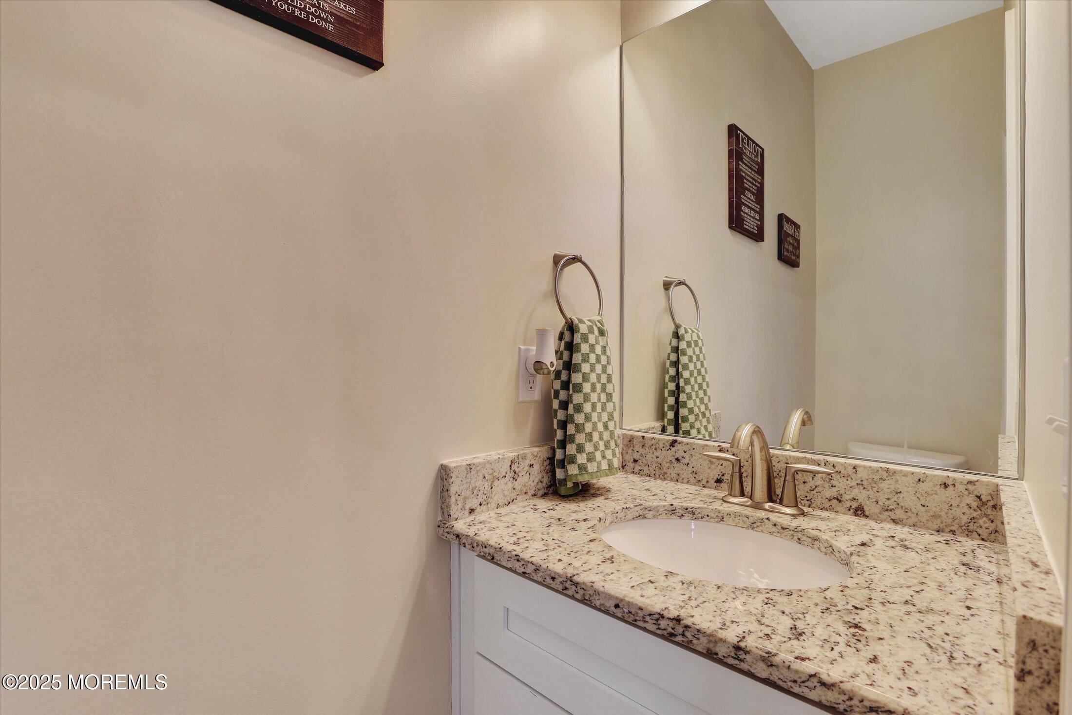 303 Prosper Way, Unit 203 Brick, NJ 08723 - Photo 10 of 36 a bathroom with a granite countertop sink and a mirror